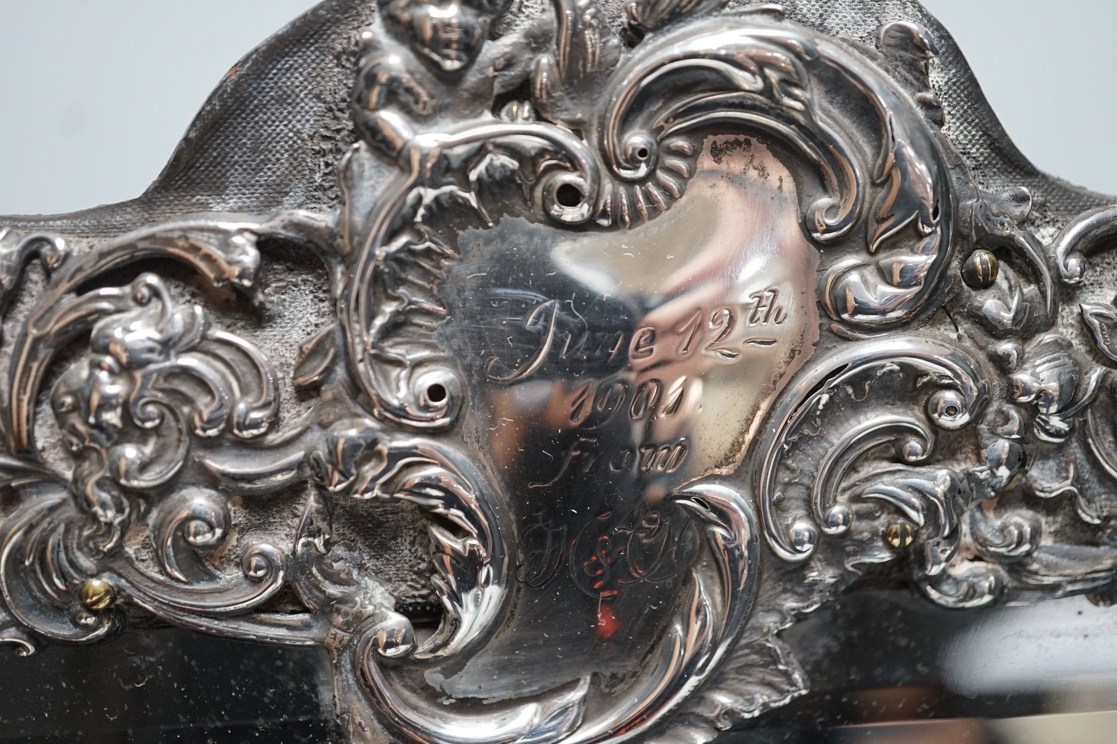 A late Victorian repousse silver mounted rectangular easel mirror, William Comyns, London, 1900, 39.8cm.